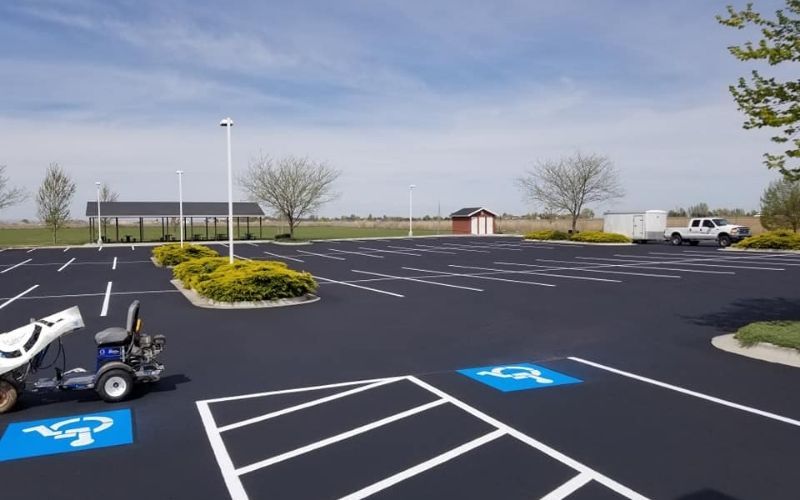 Freshly maintained commercial parking lot with accessible striping
