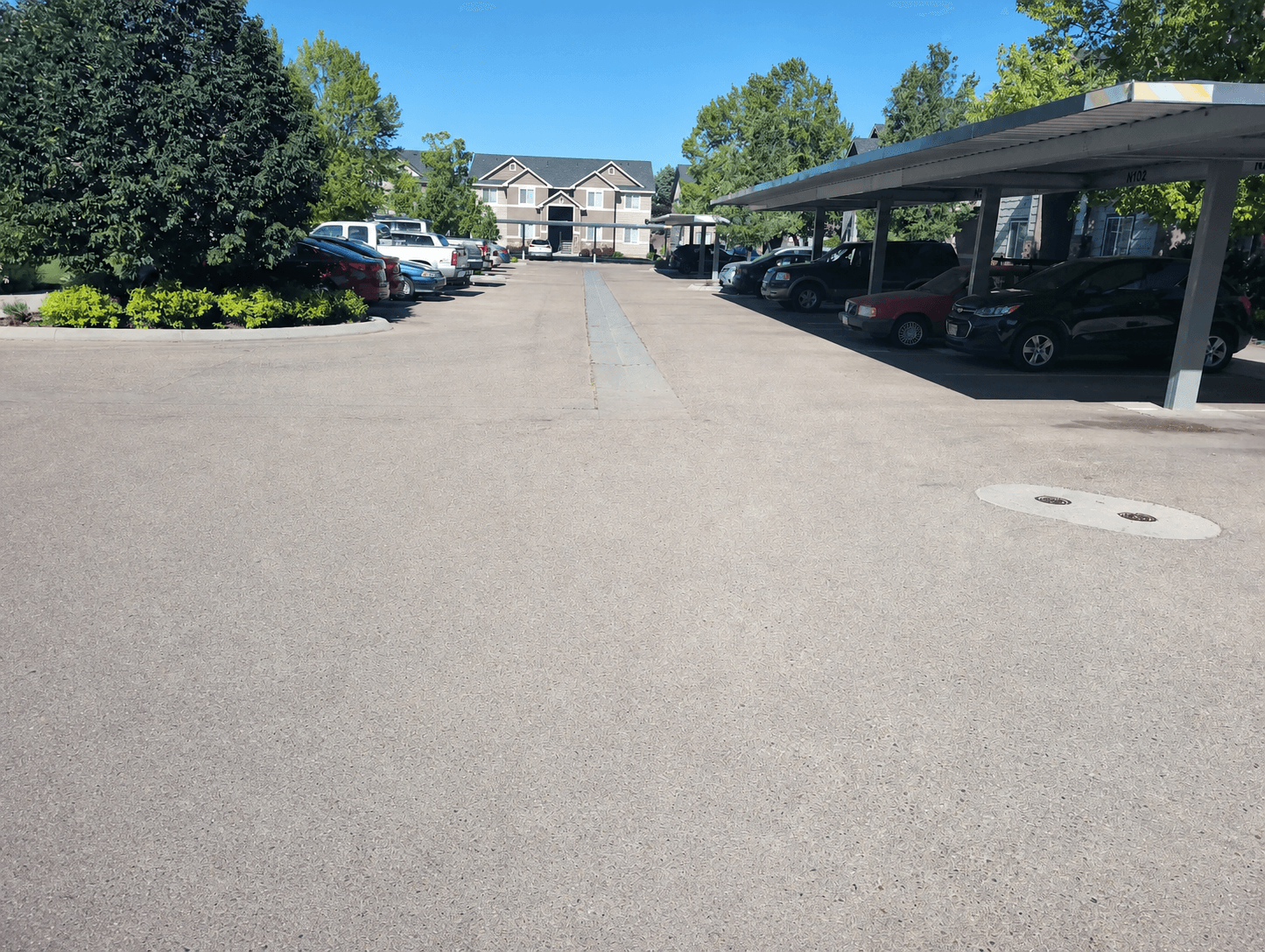 Faded central drive lane at Touchstone Place Apartments before sealcoating