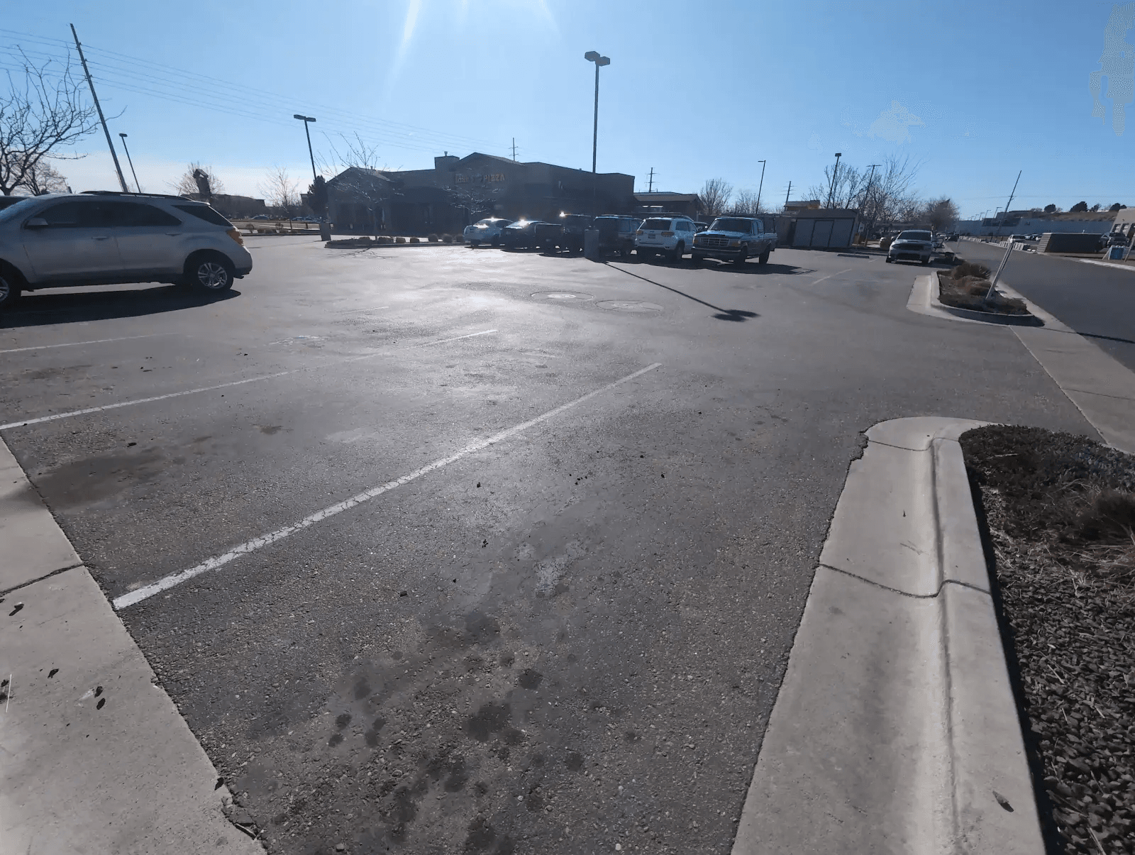 Faded Idaho Pizza Company parking lot before asphalt maintenance