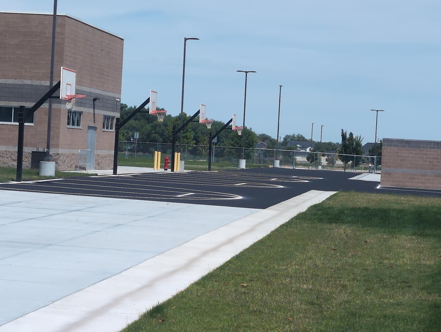 Freshly sealcoated and striped basketball court area at Summitvue Middle School